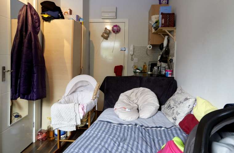 A bedroom set up for room-sharing with the parents but the room and the bassinet are not SafeSleep360°.